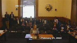 Allyson Mitchell sits in front of Indiana legislators testifying in support of HB1226